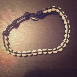 White beaded bracelet with black string/boarders